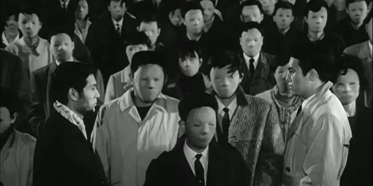 Image from The Face of Another: A crowd of people without faces