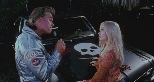 Stuntman Mike (Kurt Russell) tries to convince Pam (Rose McGowan) to take a ride with him in DEATH PROOF