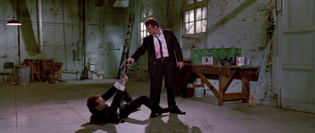 Mr. Blonde (Harvey Keitel) and Mr. Pink (Steve Buscemi) point guns at each other following a dispute in RESERVOIR DOGS.