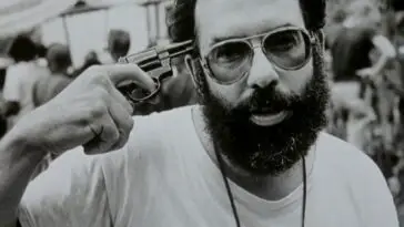 Francis Ford Coppola holds a gun to his head on the set of Apocalypse Now