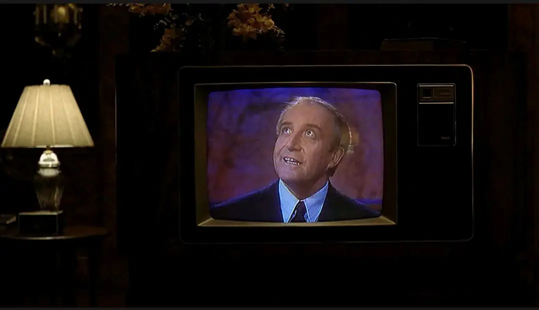 A medium shot of a television set with Chance (Peter Sellers) looking up off-camera