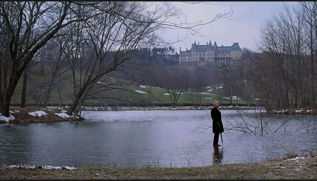 A long shot of Chance (Peter Sellers) standing directly on top of a large lake