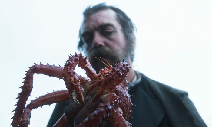 Luciano (Gabriele Silli) holds a crab.