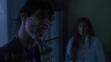 Possessed Richard stands with his mouth open and a female behind him.