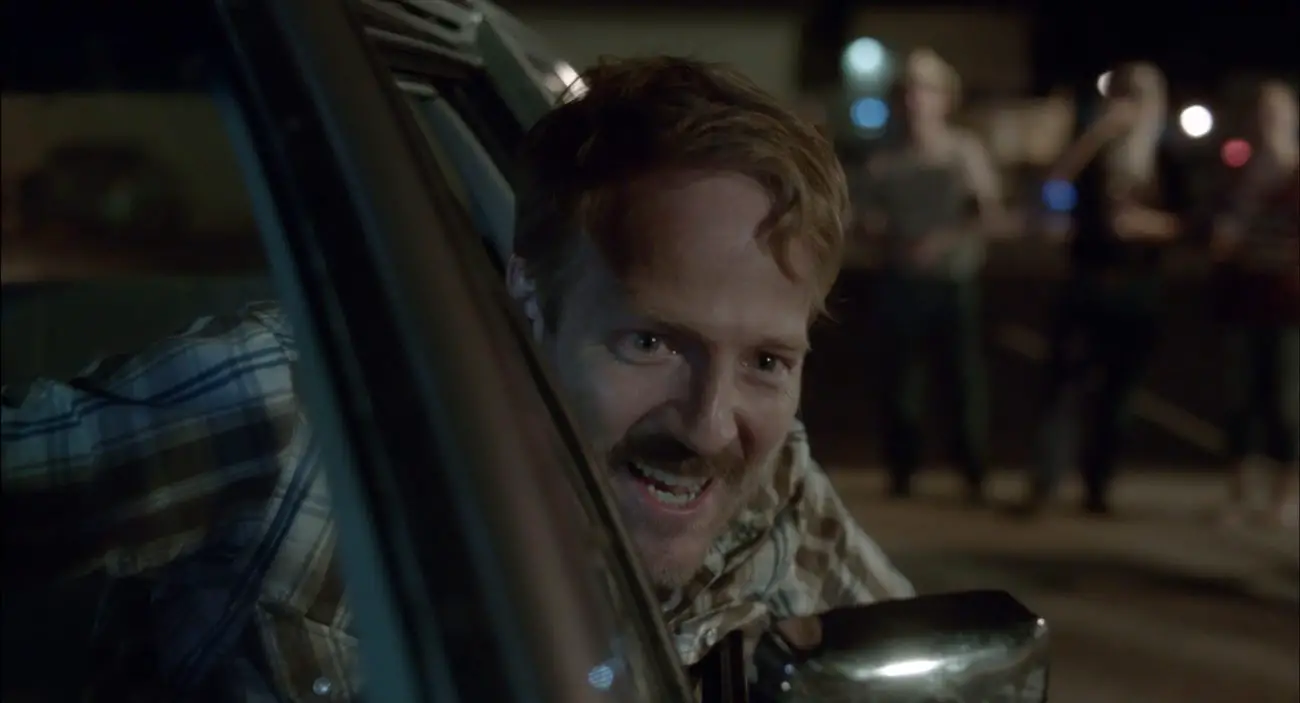 David Sullivan as Wayne Stobierski, grinning drunkenly behind the wheel of his car