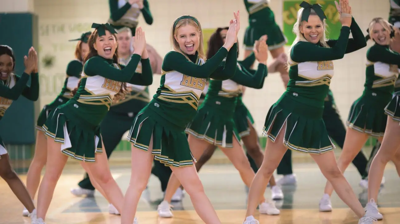 A group of cheerleaders clap in unison.
