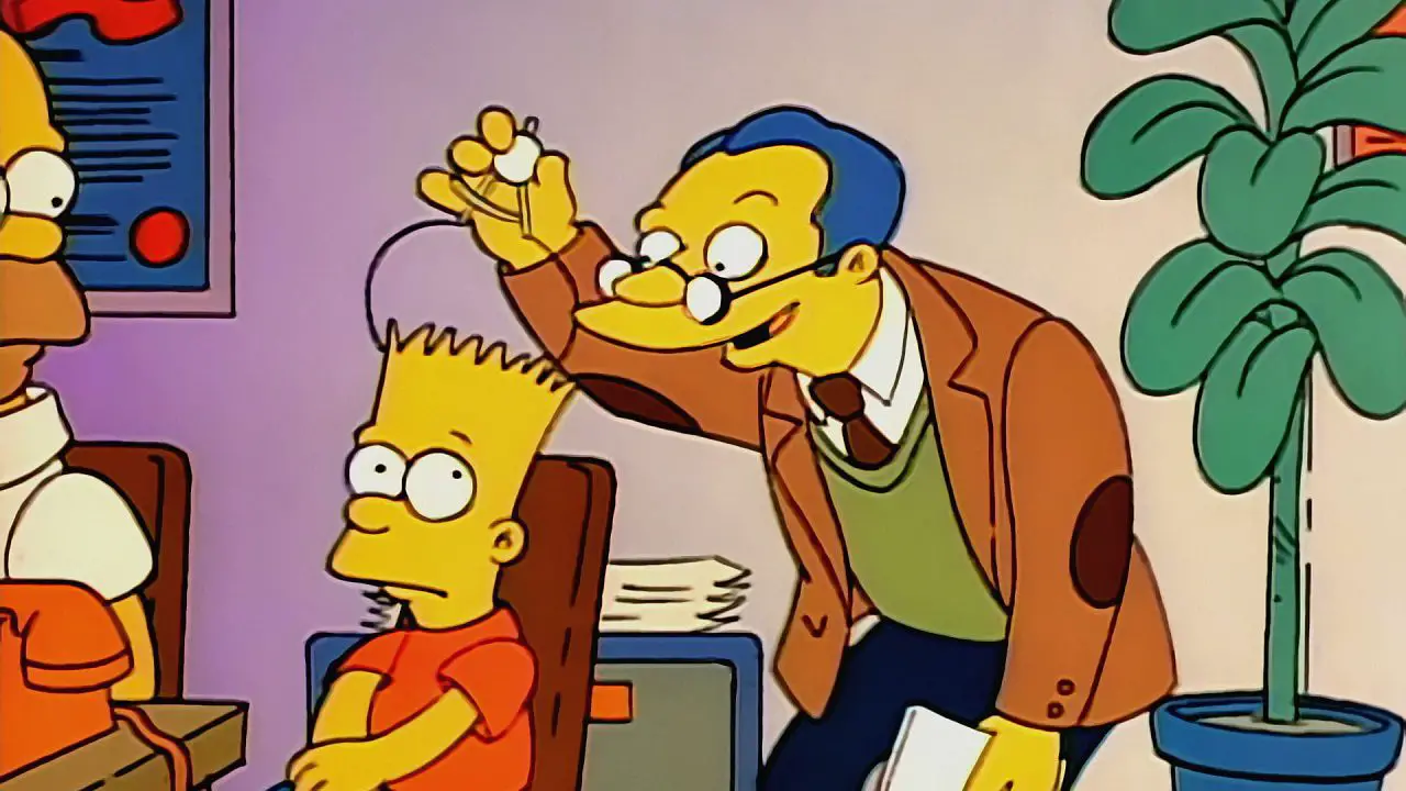 Bart sitting in a chair, his head measured by a psychologist.