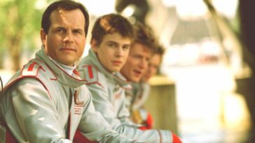 Bill Paxton and his crew, dressed in flight uniforms, gaze into the camera