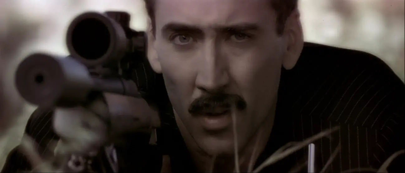 Image from Face/Off: Castor Troy (Nicolas Cage) takes aim at FBI Agent Sean Archer.