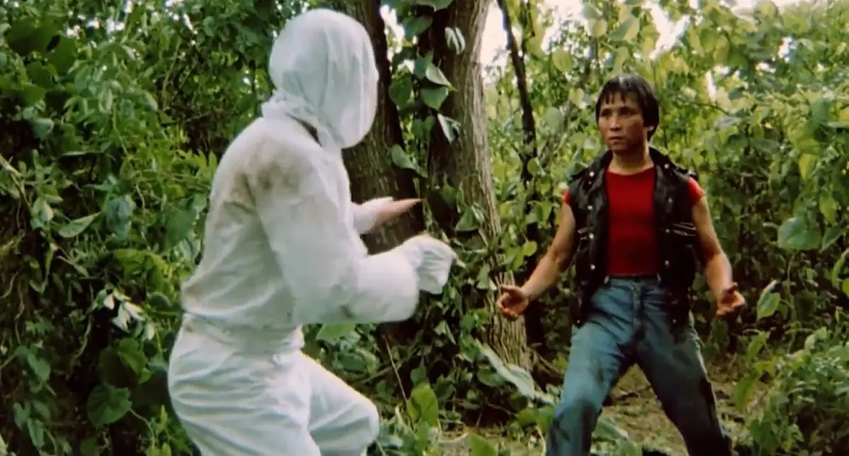 Mark in the jungle facing off with a white-clad ninja.