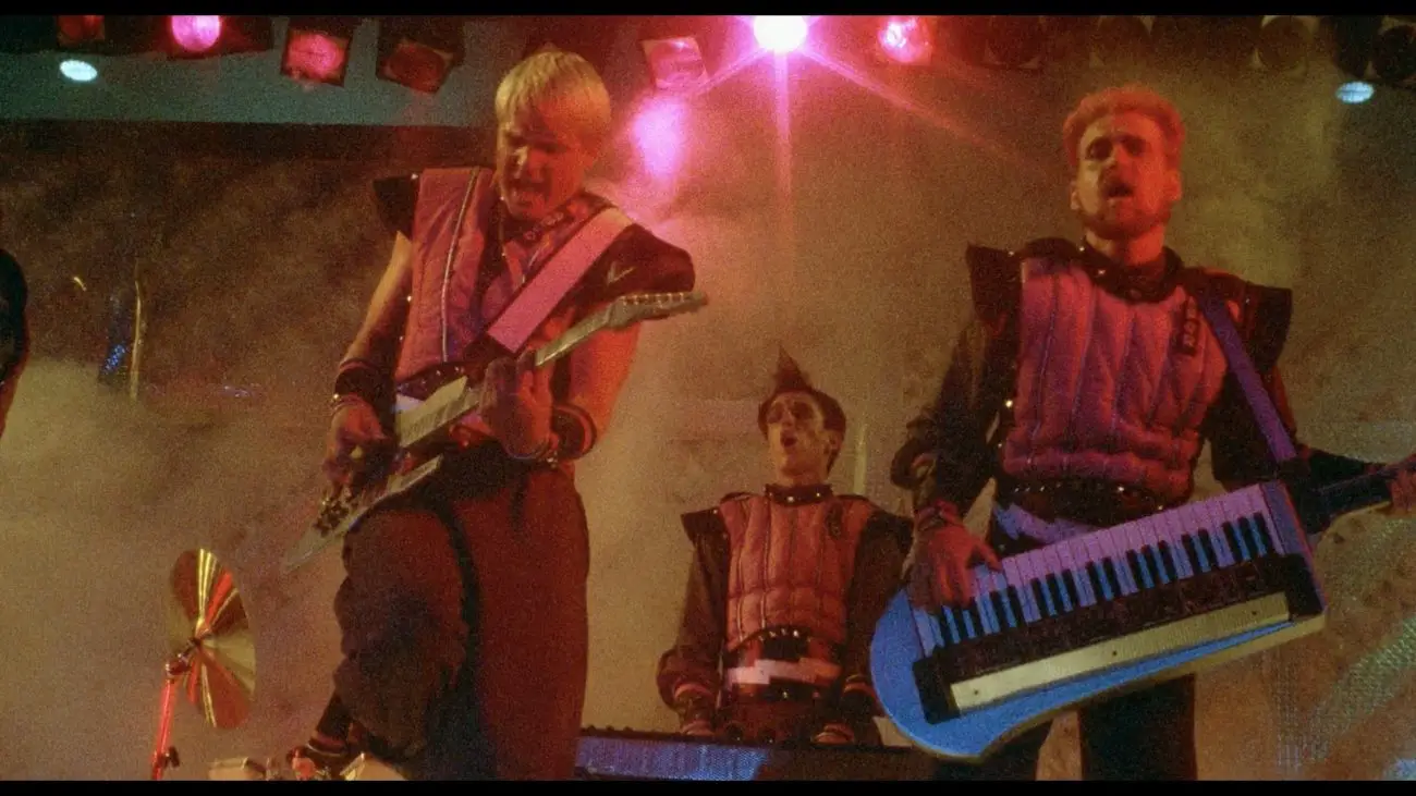 The Rock Aliens playing their instruments during a battle of the bands.
