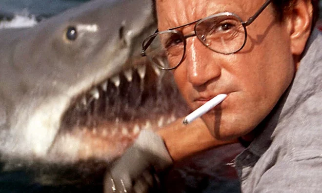 Brody (Roy Scheider) is unexpectedly visited by a giant shark while throwing chum into the water in JAWS