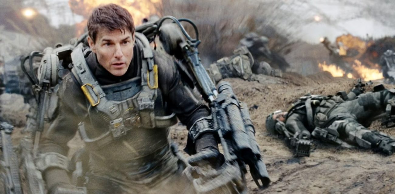 A man in an exo-suit of armor steps through a battlefiend.