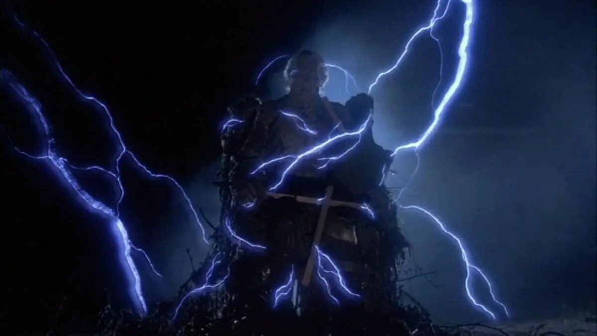 The corpse of Forsythe above ground with lightning around him.