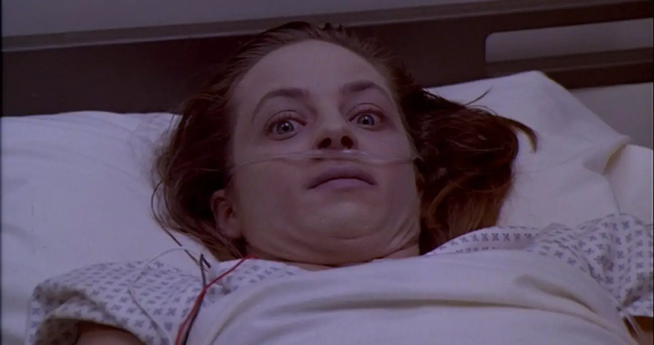 Jack's wife lying awake in a hospital bed.