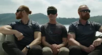 Miles Teller, playing Jeff in Spiderhead, sits blindfolded on a high-speed boat as he's transferred to the Abnesti headquarters.