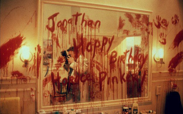 A bloody bathroom with a threating message on the mirror.
