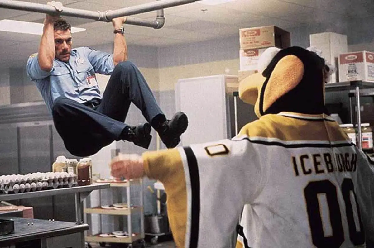 McCord swings on a pipe towards the Penguins mascot.