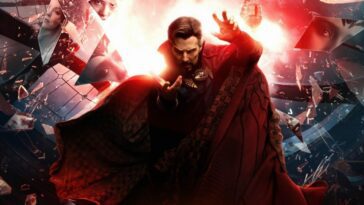 A piece of the film's poster featuring Stephen Strange (Benedict Cumberbatch) posing dramatically in front of the a large window, shards of which are flying into the foreground with parts of faces visible in them, as a red light shines in the background.