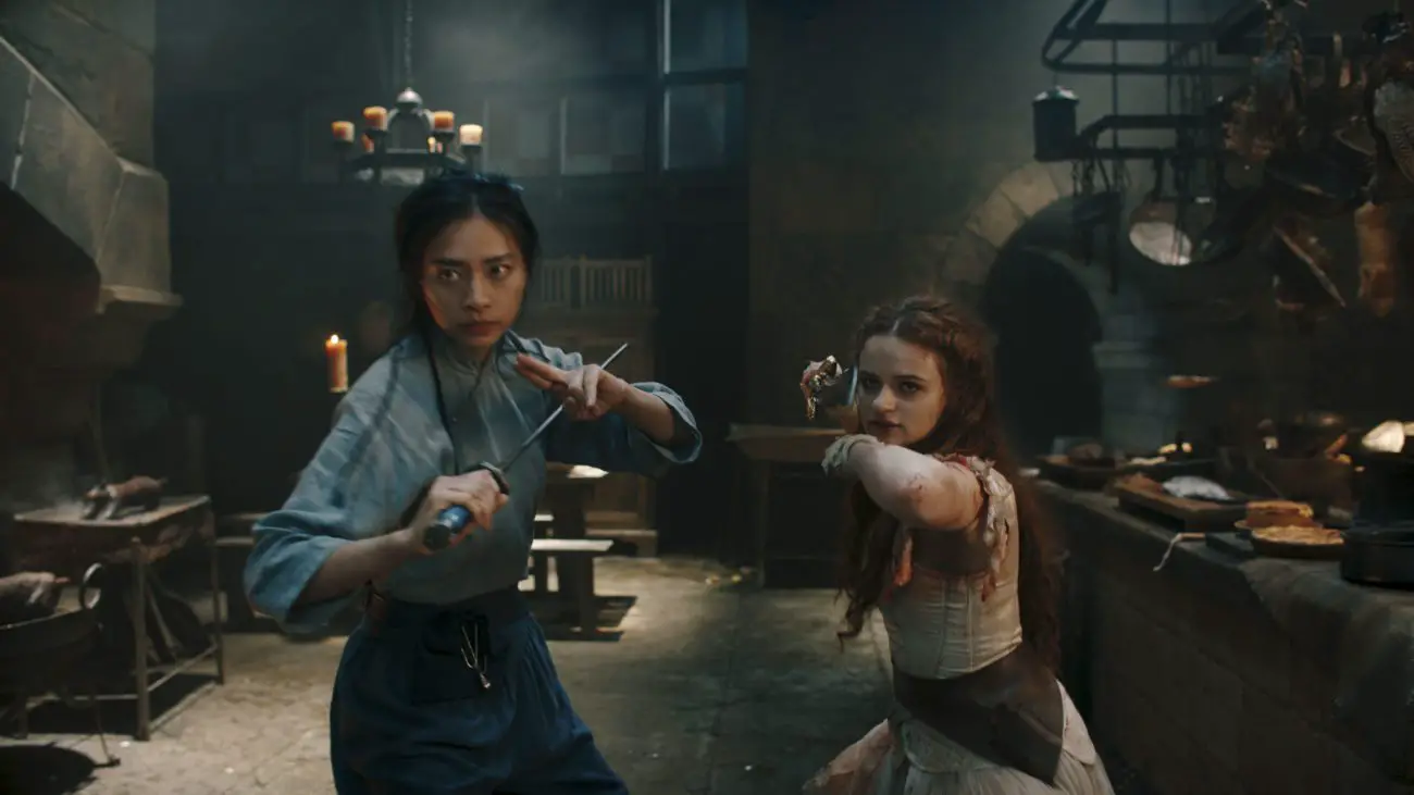 Two women with blades stand ready for a fight.