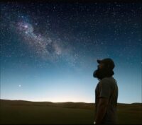 Laal Singh Chaddha (Aamir Khan) looks into the night sky after running for multiple years.