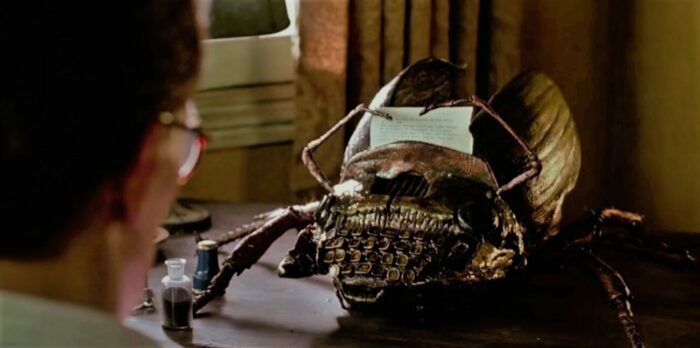 A mechanical typewriter mutating into a scarab like hybrid, an insectoid typewriter