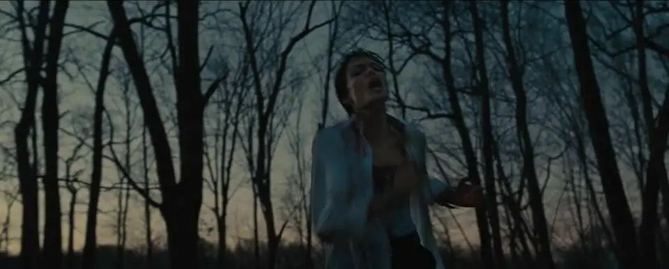 Evelyn Salt (Jolie) runs through a forest