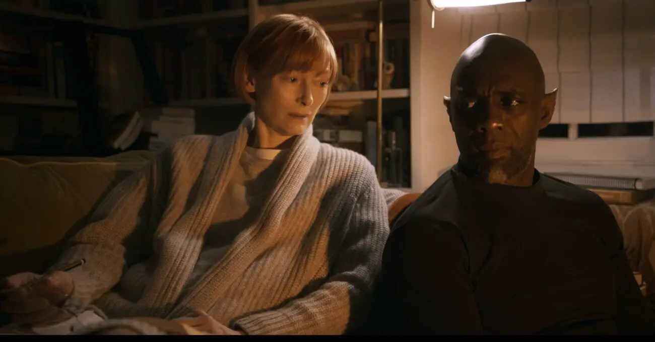Alithea (Tilda Swinton) and Djinn (Idris Elba) have a tender moment at night. 