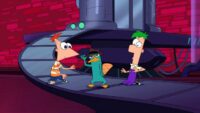 Perry stands between a stunned Phineas and Ferb and puts on his secret agent hat.