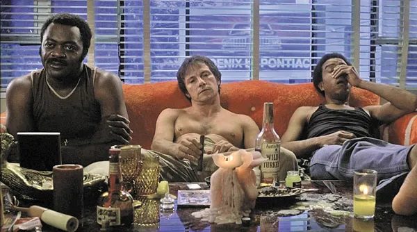 Yaphet Kotto, Hervey Keitel and Richard Pryor sit on a couch in front of drug paraphernalia.