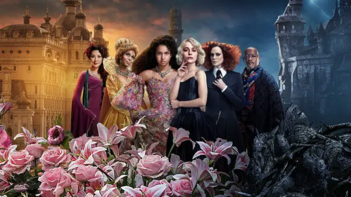 The School of Good and Evil wide netflix poster: L-R - Michelle Yeoh, Kerry Washington, Sofia Wylie, Sophia Anne Caruso, Charlize Theron, Laurence Fishburne. The school is in the background, and pink flowers are in the foreground.