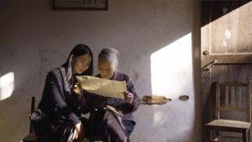 Hu Xiu shows her mentor He Yanxin a Nushu text she wrote for her