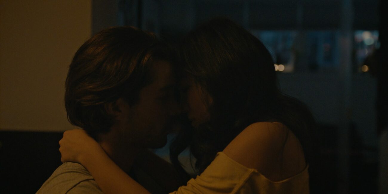 A man and woman are wrapped in romantic embrace in "Stay the Night"
