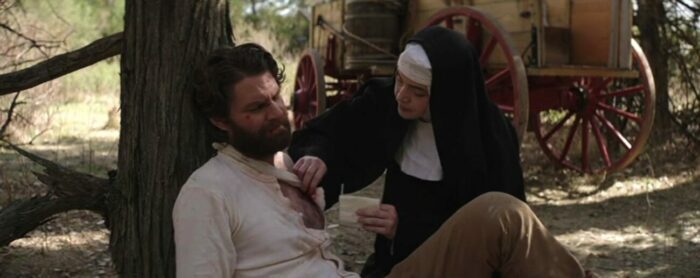 A nun tends to a man's wounds.