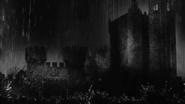 A black and white shot of a rainy castle.
