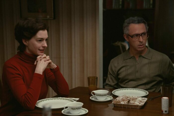 Two parents look eagerly over at their son at a dinner table in "Armageddon Time."
