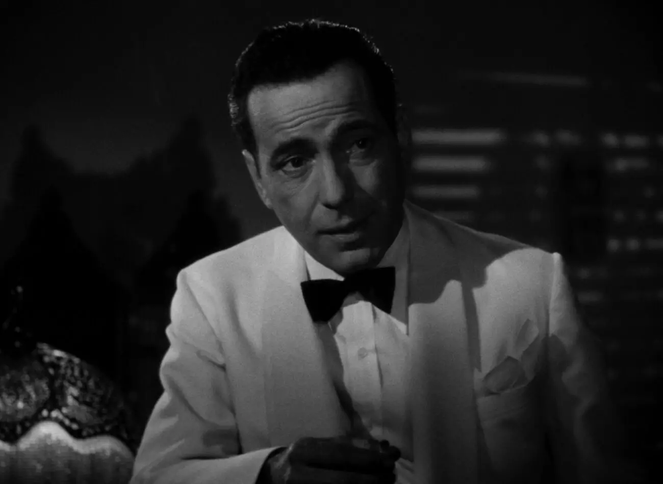 A man in a smoking jacket talks business in Casablanca