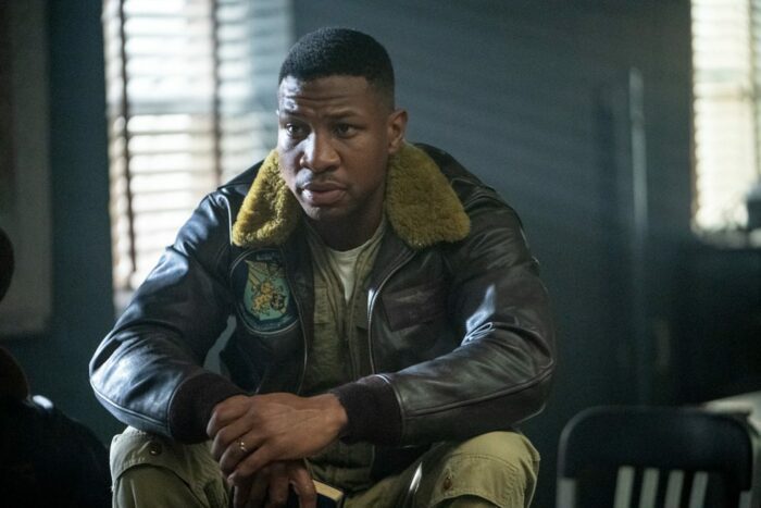 Jesse Brown (Jonathan Majors) sits in an office. 