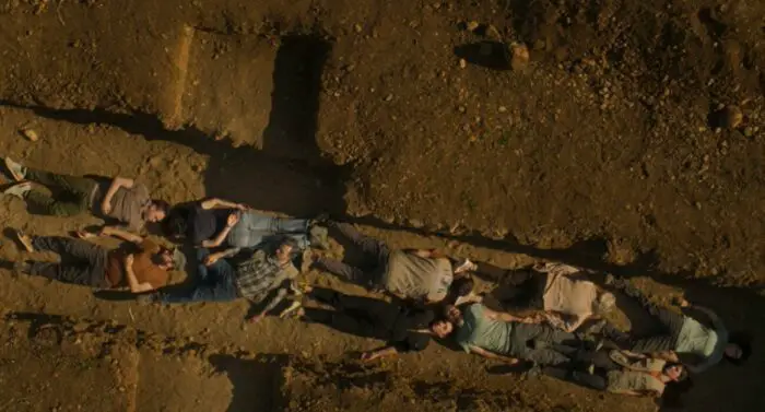 People lying in the dug up earth