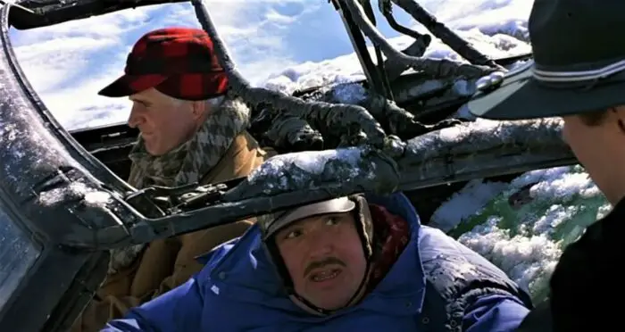John Candy and Steve Martin driving a burnt-out car in Planes, Trains, and Automobiles