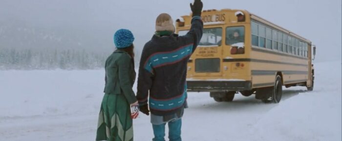 Wanda (Arsinée Khanjian) and Hartley Otto (Earl Pastko) send off their child, Bear (Simon Baker), on the school bus on a wintry day.