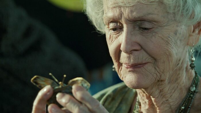 An older woman looks at a hair clip