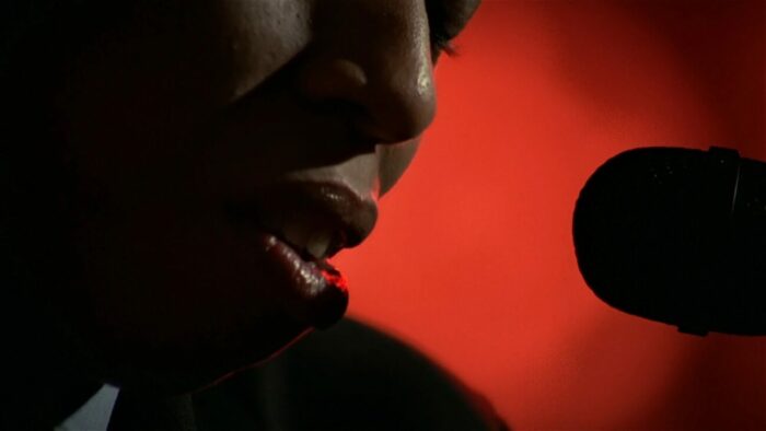 A close-up look at the DJ's mouth as she speaks into a microphone.