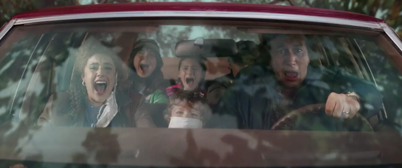 The Gladney family in their car, screaming