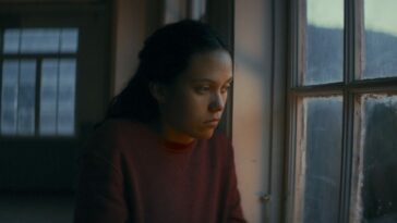 Laura Lopez as Blanquita, looking pensively out a window