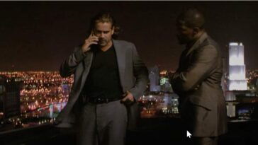 Crockett and Tubbs stand on a rooftop with the Miami skyline in the background as thunder claps in Miami Vice