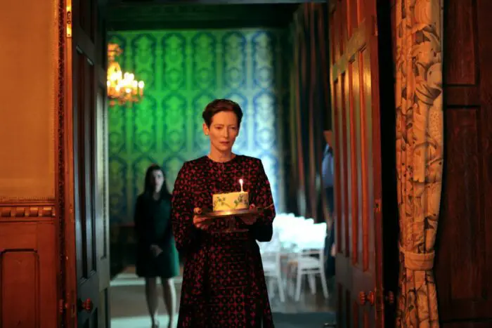 The Enteral Daughter - Tilda Swinton as Julie bringing birthday cake to her mother in hte hotel dining room
