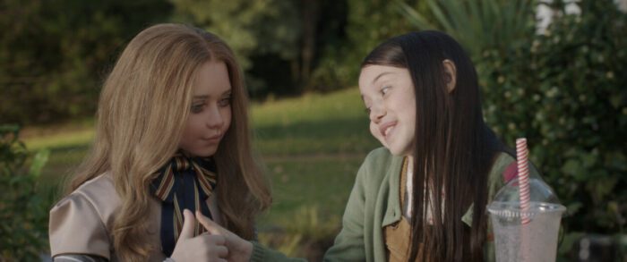 M3GAN and Cady (Violet McGraw) talk and play outdoors. 