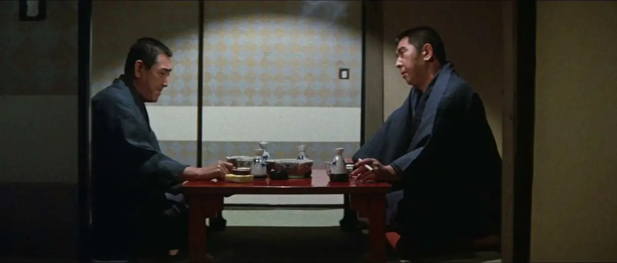 Nakai and Matsuda sit facing each other with a table between them.