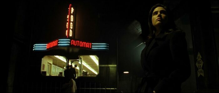 Emma outside the food automat in Dark City